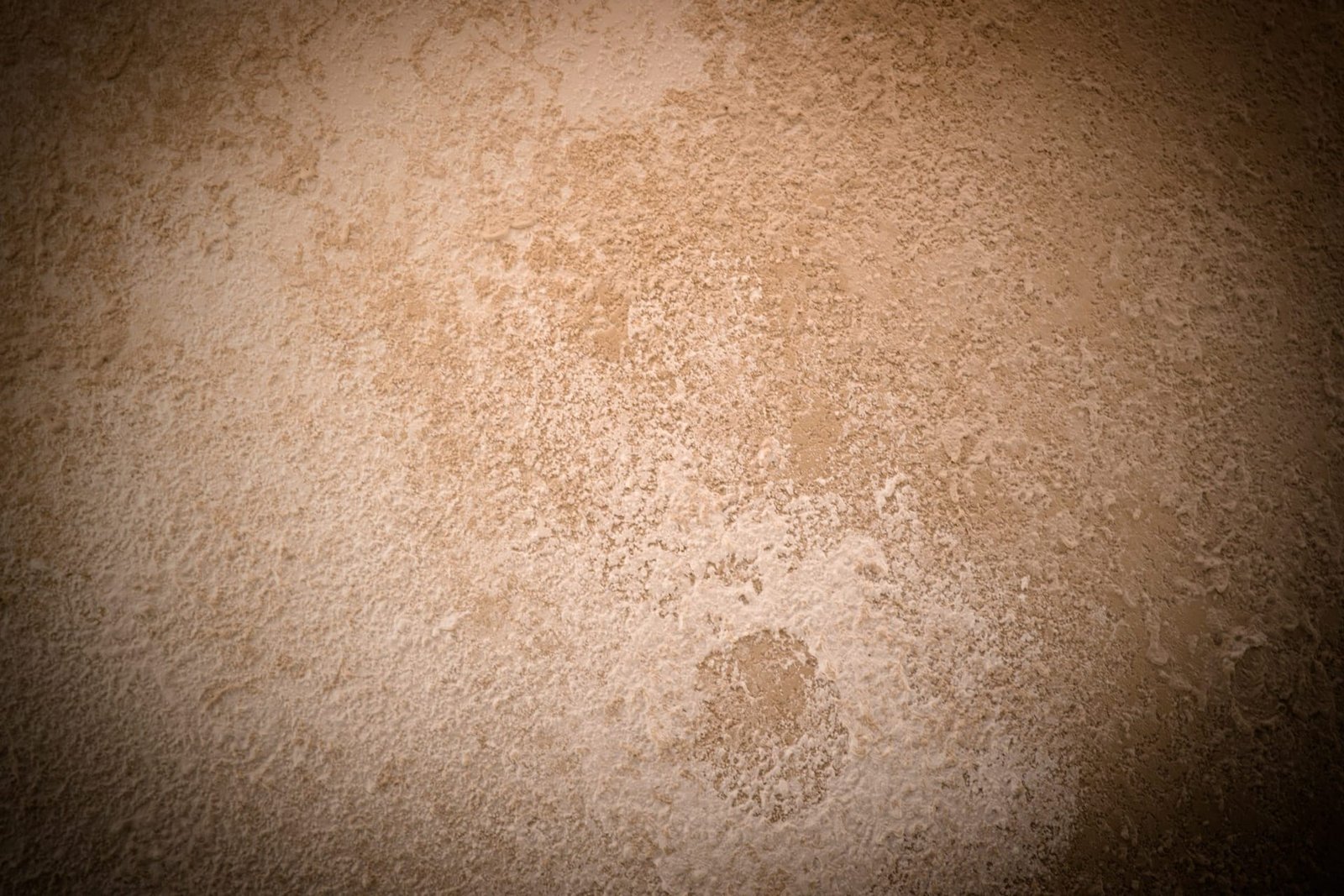 Mottled Microtadelakt polished lime plaster in warm sand tones at Afraa Boutique, Lusail