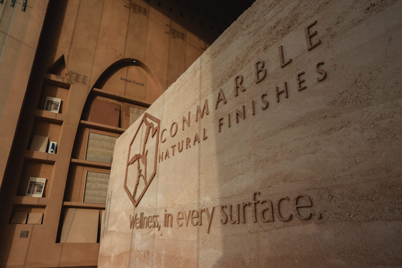 In-situ rammed earth brand wall above the sample arches, Conmarble showroom, Riyadh